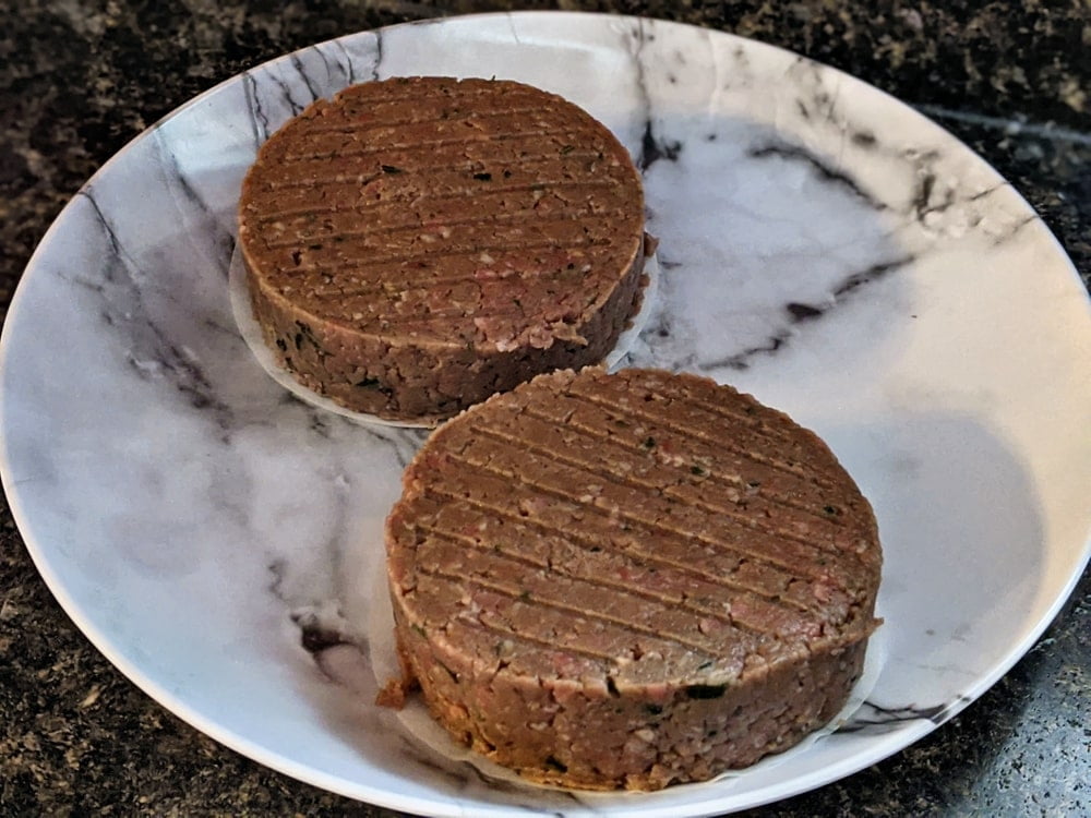 Stuffed burger patties on plate