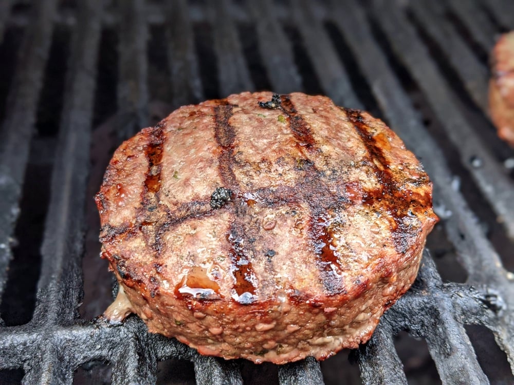 Stuffed burger patties on grill