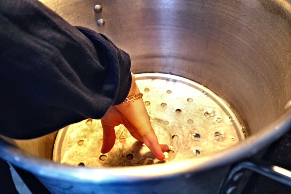 Soaking tamale husks in pot